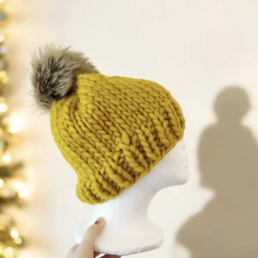 Super chunky hand knit merino wool mustard yellow beanie with faux fur pompom