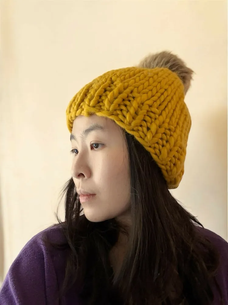 Super chunky hand knit merino wool mustard yellow beanie with faux fur pompom