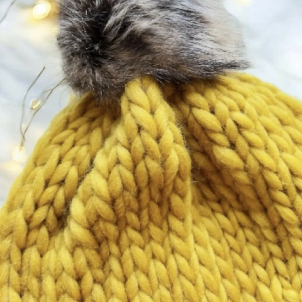 Super chunky hand knit merino wool mustard yellow beanie with faux fur pompom
