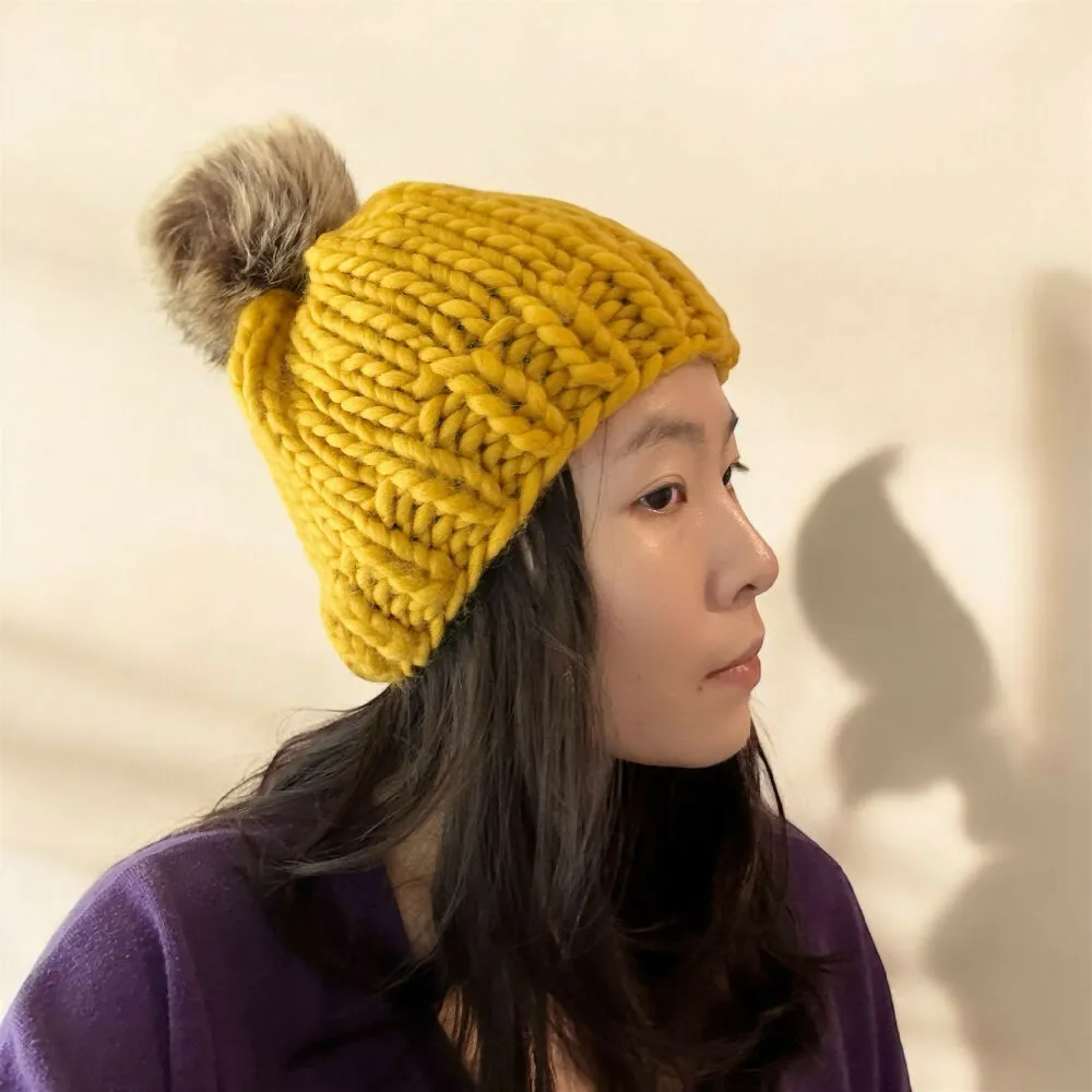 Super chunky hand knit merino wool mustard yellow beanie with faux fur pompom