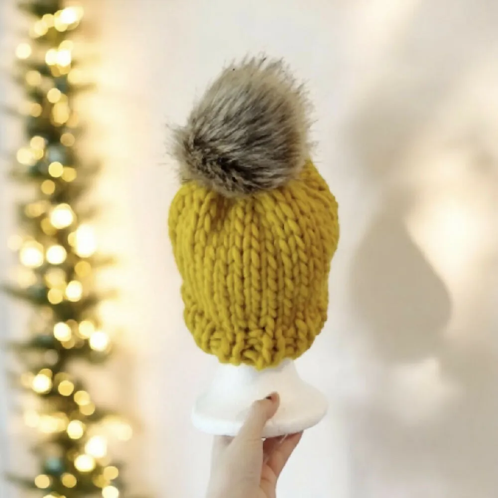 Super chunky hand knit merino wool mustard yellow beanie with faux fur pompom
